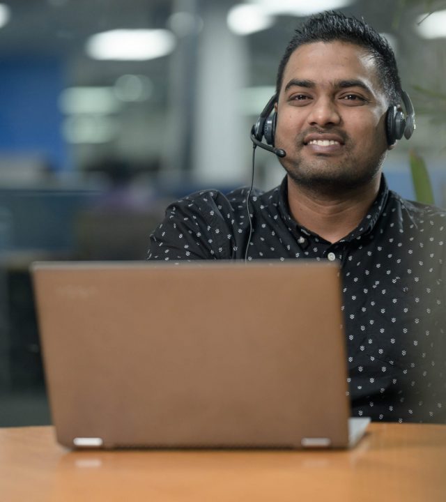 A male call center agent that is making outbound calls at the 'best bpo outsourcing provider in australia', also known as packleaderbpo.